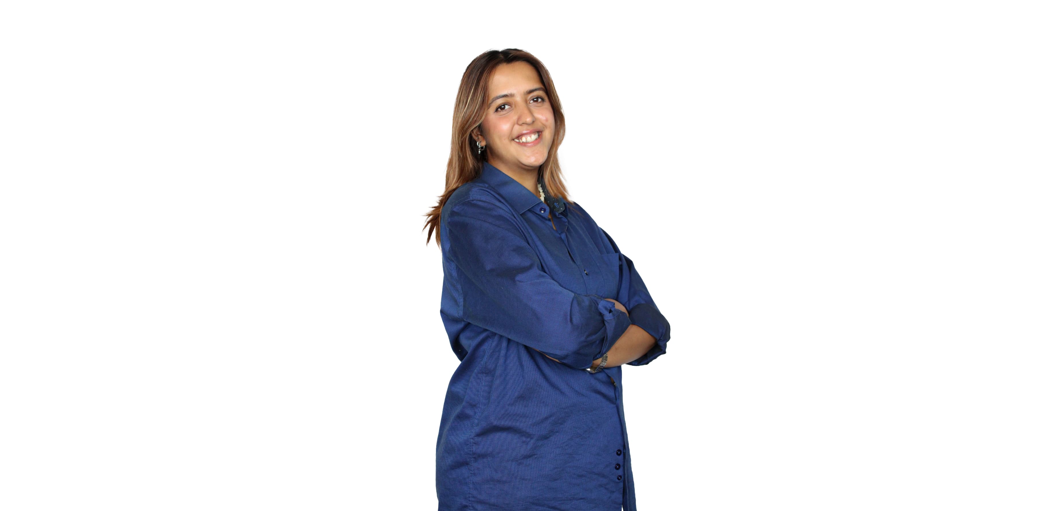 https://media.devpulse.info/A young woman with brown hair and a blue shirt stands with her arms crossed, smiling slightly.